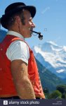 a-swiss-man-smoking-a-pipe-in-traditional-alpine-costume-at-the-unspunnen-AJ2THY.jpg
