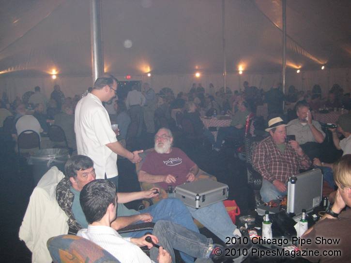 Kevin (standing) talking with Bob Gilbert, Pipe Maker in the Smoking Tent