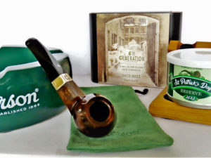 Sherlock Holmes Smooth Dark Stained Hudson is center stage. It came with Cornell& Diehl's St. Patrick's Day Special Reserve 2022 small batch blend of Bright Virginias, hazelnut, vanilla, a variety of canvendish and a smooth creamy topping. A lovely blend. In the background is 2021/2022 4th Generation limited edition Jubilaeums Flake, a tobacco blend dedicated to Erik Stokkebye's grandfather, Erik Poul. Photo by Fred Brown
