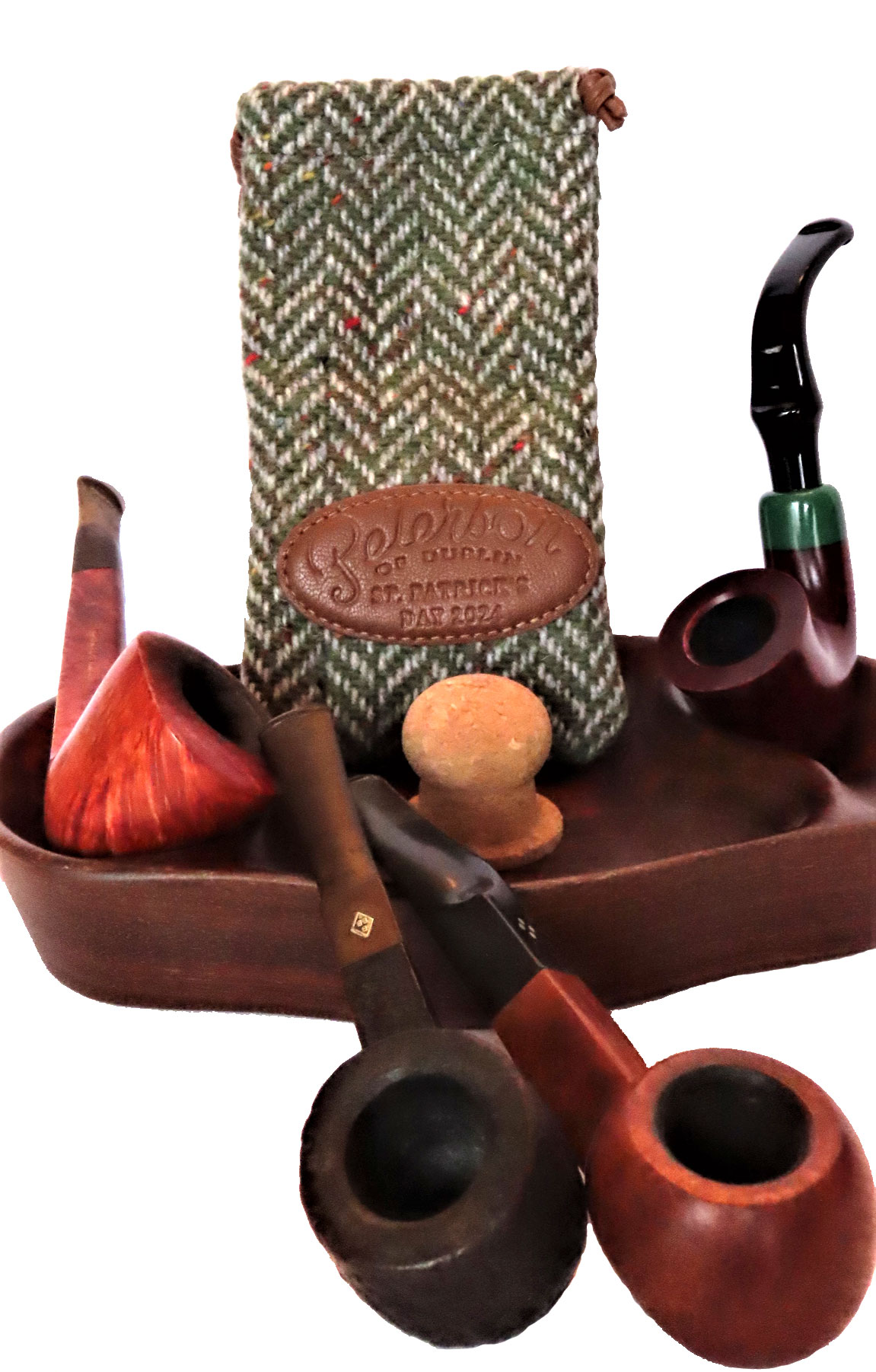 Old members of the pipe herd (bottom left) and latest addition, Peterson St. Patrick's Day St. Patrick’s Day pipe at right. The Pete is adorned with an Irish green cap on the Peterson 305 Calabash, one of the famous Dublin pipe manufacturer’s most popular shapes. (Photo: Fred Brown)